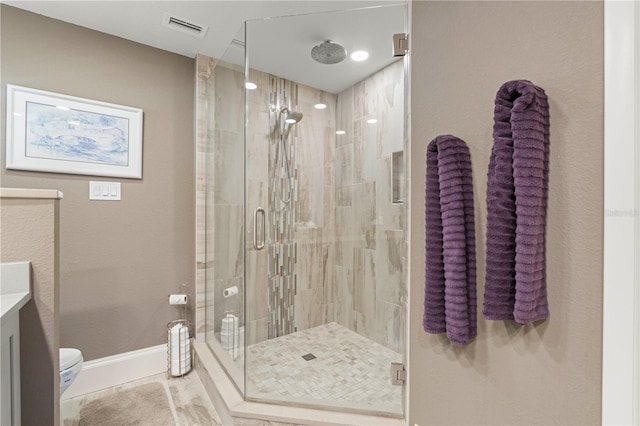 bathroom featuring tile patterned floors, toilet, an enclosed shower, and vanity