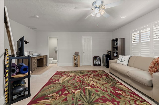 living room featuring a textured ceiling and ceiling fan