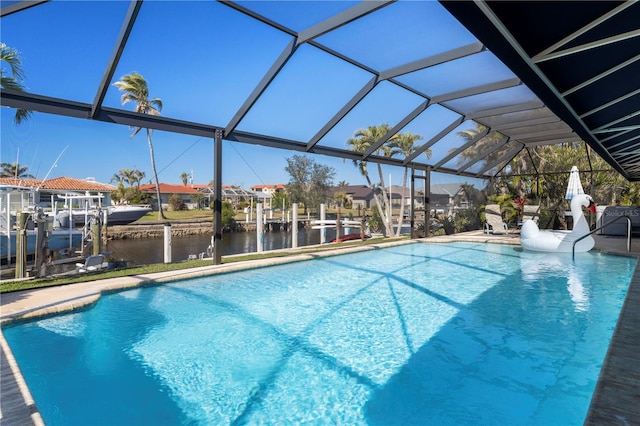 view of swimming pool featuring a water view and glass enclosure