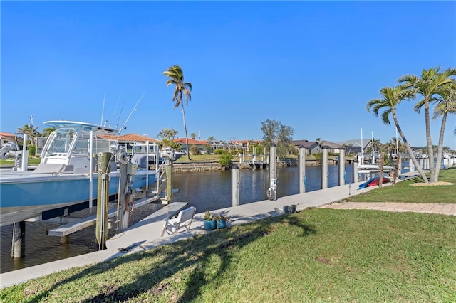 view of dock with a yard and a water view