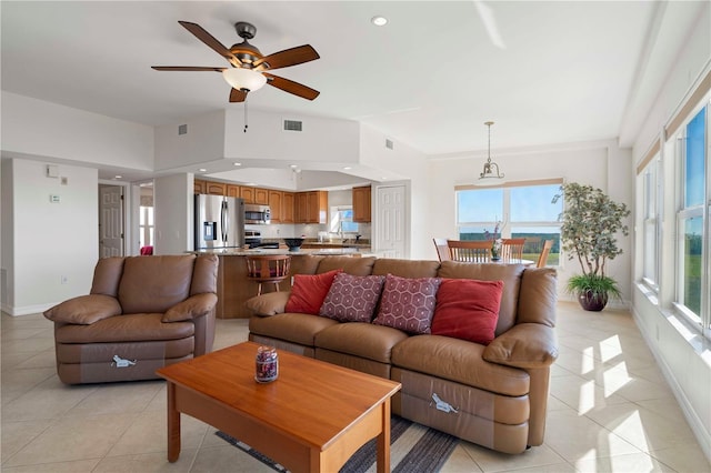 tiled living room with ceiling fan