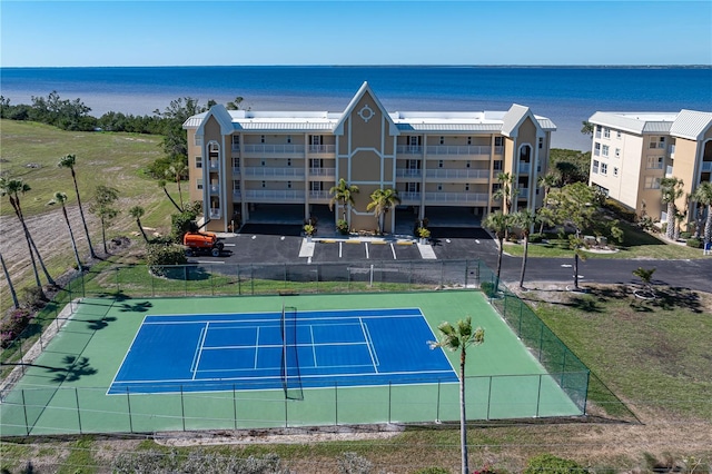 view of sport court with a water view