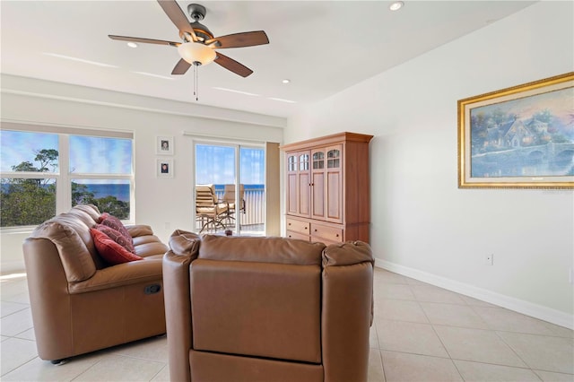 living room featuring light tile patterned floors and ceiling fan