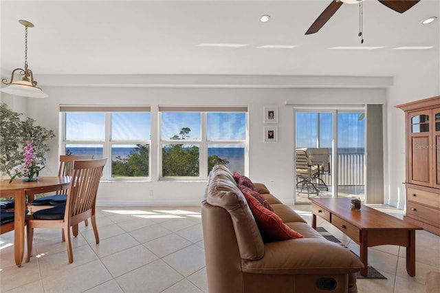 living room featuring ceiling fan and light tile patterned flooring