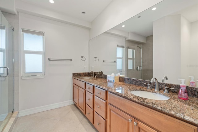 bathroom with vanity, an enclosed shower, and tile patterned flooring