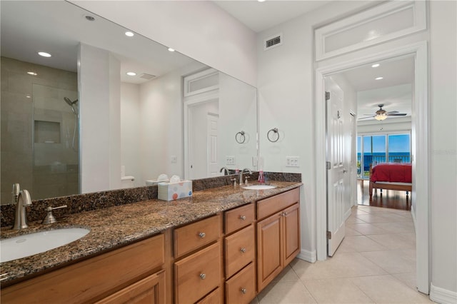 bathroom with vanity, tile patterned floors, ceiling fan, and walk in shower