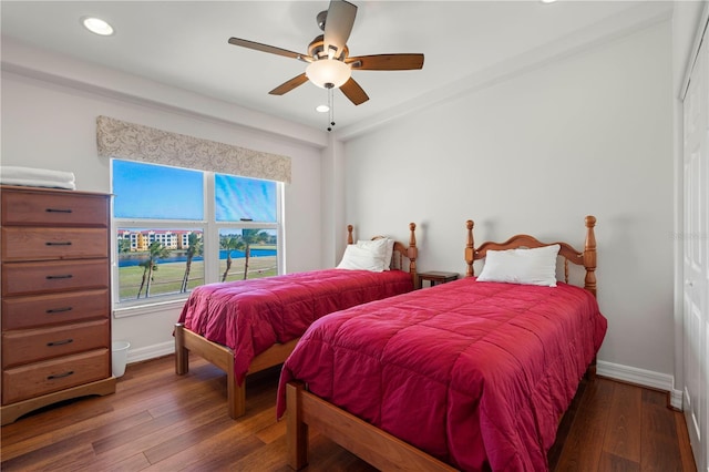 bedroom with dark hardwood / wood-style floors and ceiling fan