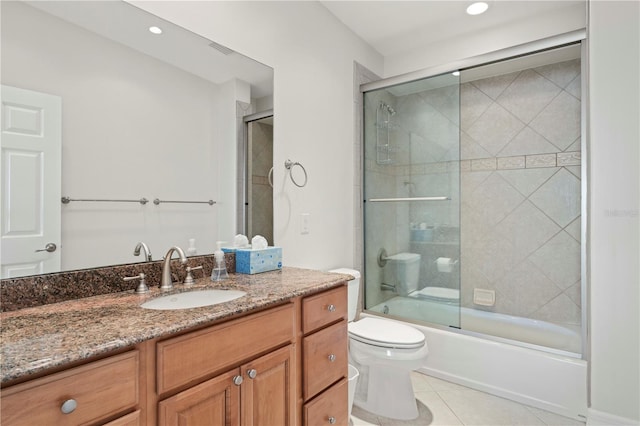 full bathroom with enclosed tub / shower combo, toilet, tile patterned floors, and vanity