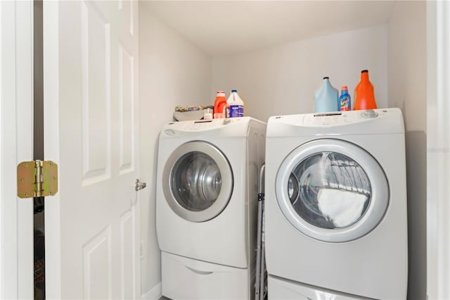 clothes washing area featuring washer and clothes dryer