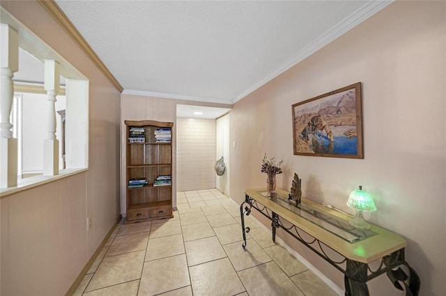 hallway featuring ornamental molding and light tile patterned floors