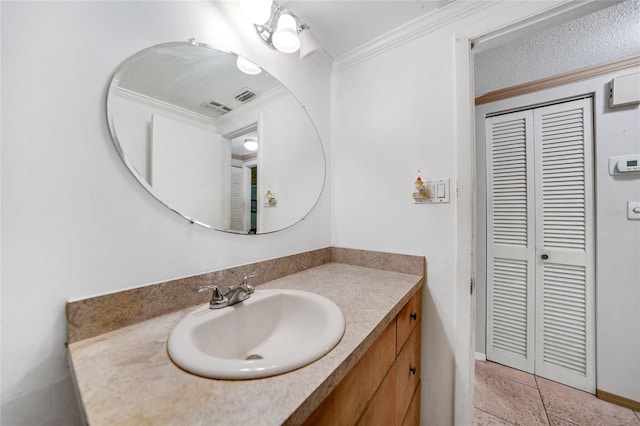 bathroom with ornamental molding and vanity