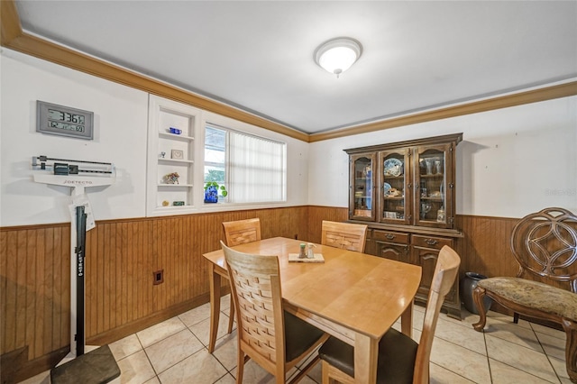 dining room featuring crown molding, built in features, and light tile patterned flooring