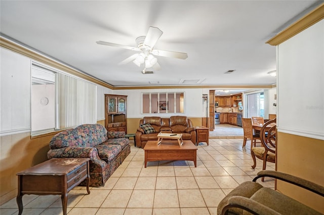 tiled living room featuring ornamental molding and ceiling fan