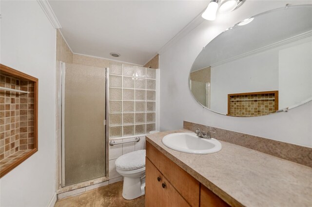 bathroom with crown molding, tile patterned flooring, vanity, toilet, and walk in shower