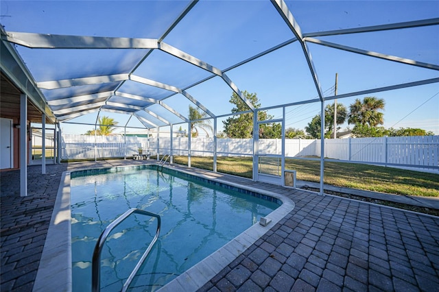 view of swimming pool with a lanai and a patio area