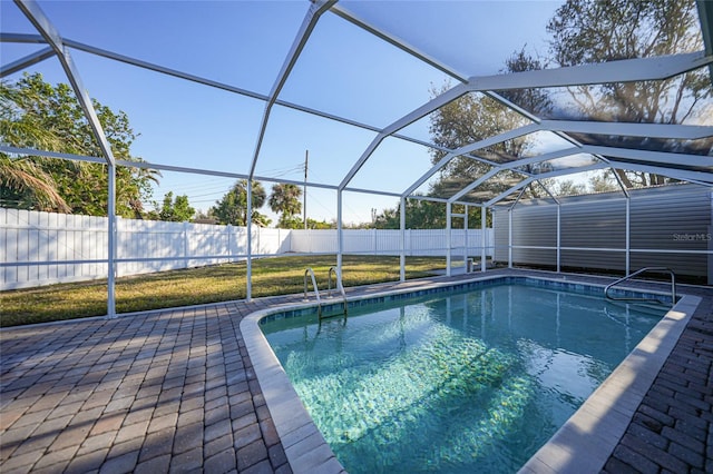 view of swimming pool with a patio and glass enclosure