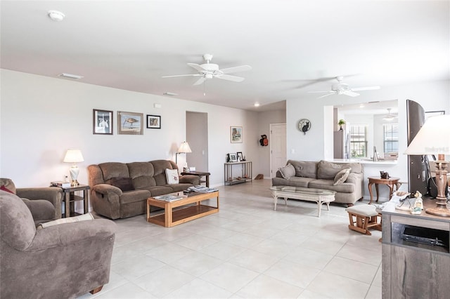 tiled living room with ceiling fan