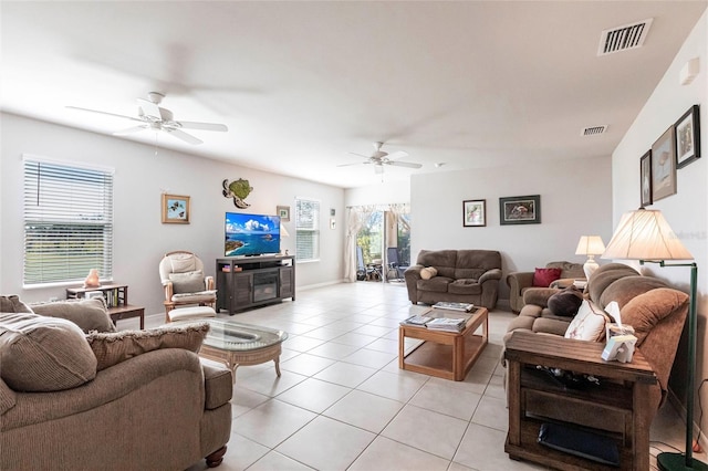 living room featuring light tile patterned flooring and ceiling fan