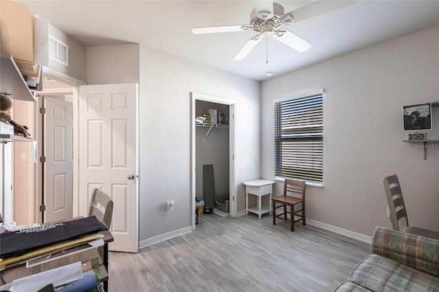 home office featuring ceiling fan and light hardwood / wood-style floors