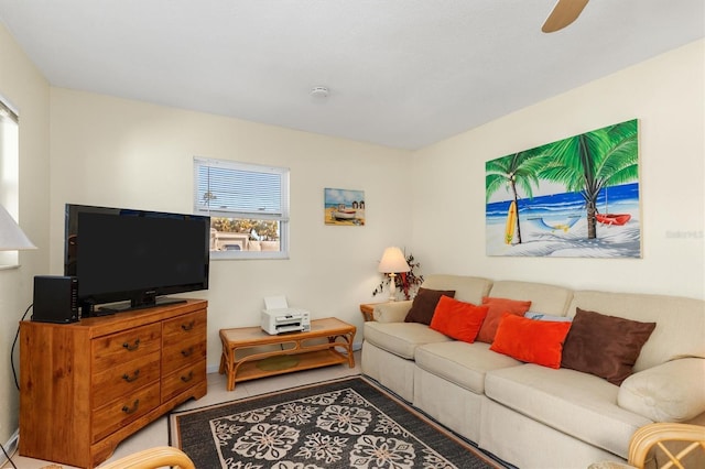 living room featuring tile patterned floors and ceiling fan