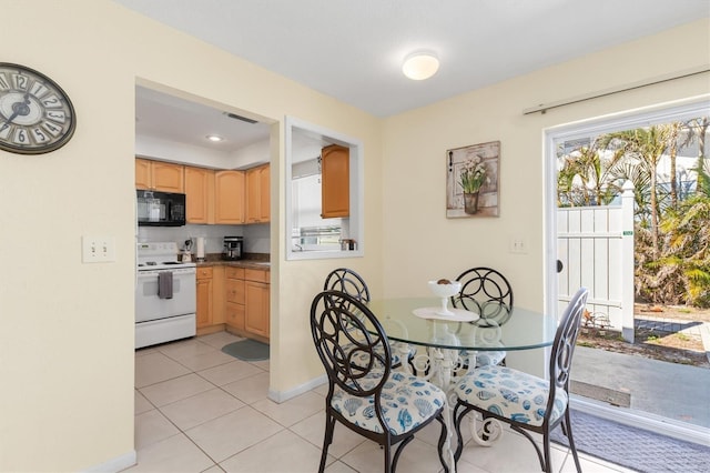 dining area featuring light tile patterned floors