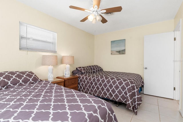 tiled bedroom with ceiling fan