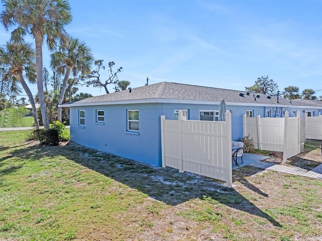 view of property exterior with a lawn