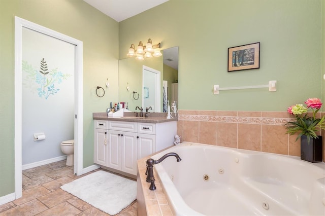 1020 Caliva St, North Port, FL 34286 - full bath with toilet, vanity, a tub with jets, baseboards, and stone finish floors