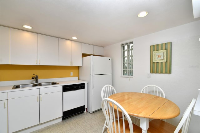 kitchen featuring white appliances, sink, and white cabinets