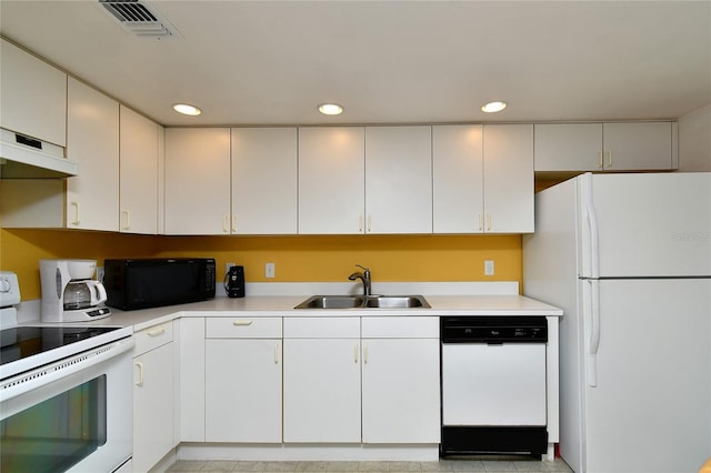 kitchen featuring white appliances, sink, and white cabinets