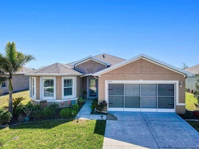 single story home with a garage and a front lawn