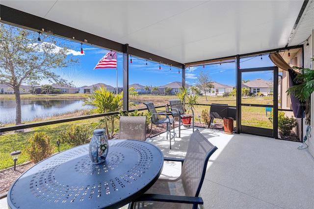 sunroom with a water view and a wealth of natural light