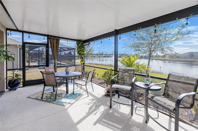 sunroom featuring a water view and a wealth of natural light