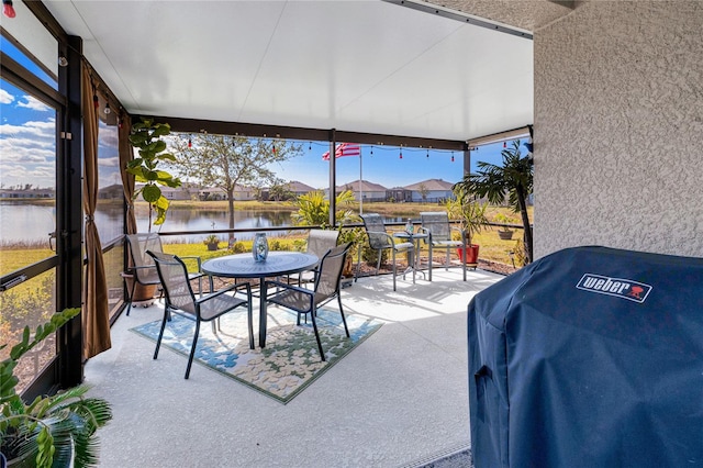 sunroom / solarium with a water view