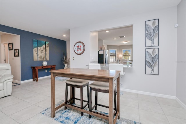 kitchen with stainless steel fridge and light tile patterned floors