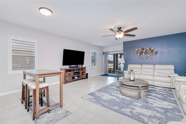 tiled living room featuring ceiling fan