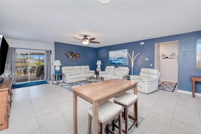 tiled dining space with ceiling fan