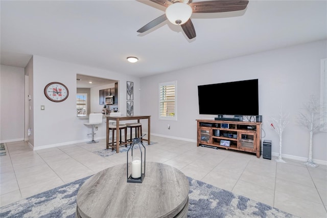 tiled living room featuring ceiling fan