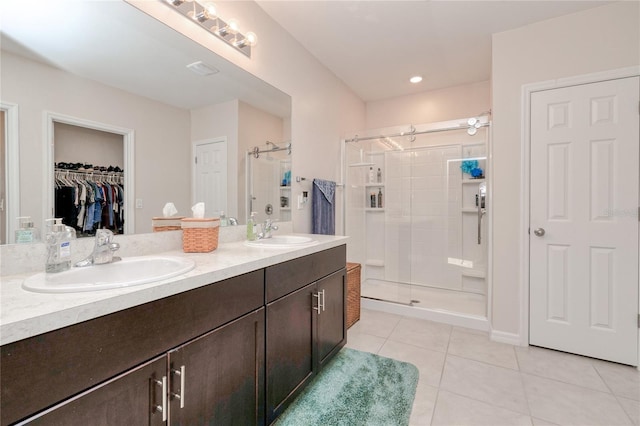 bathroom with vanity, tile patterned floors, and a shower with shower door