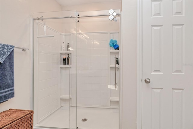 bathroom with a shower with shower door