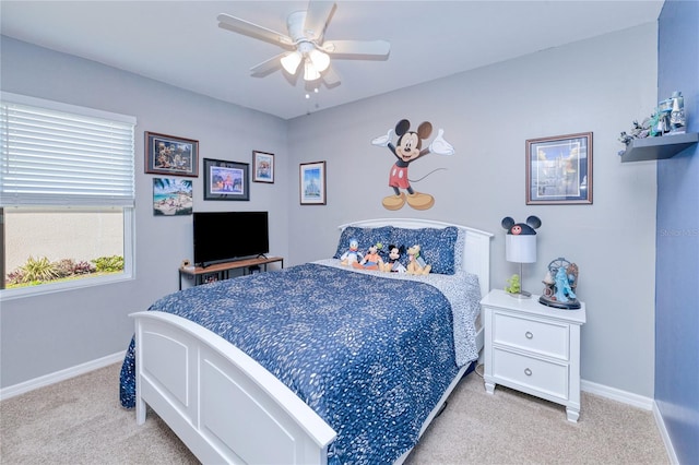 bedroom featuring light colored carpet and ceiling fan