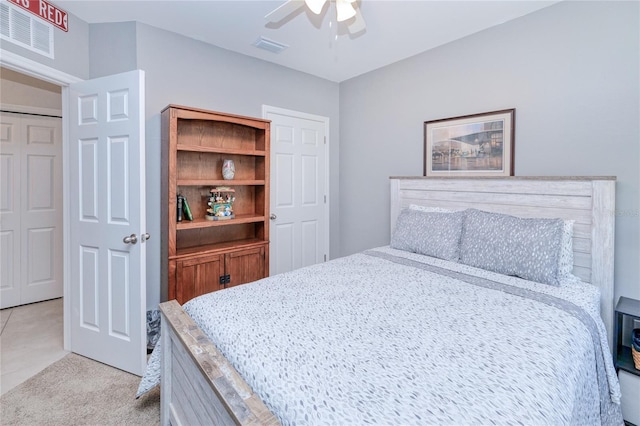 carpeted bedroom featuring a closet and ceiling fan