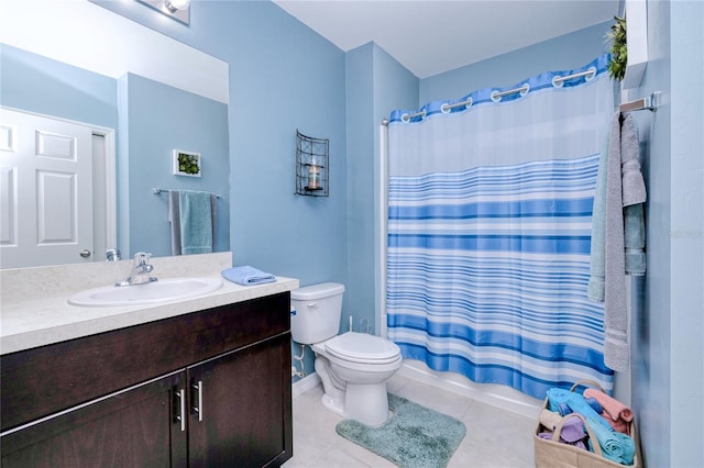 full bathroom featuring tile patterned flooring, vanity, toilet, and shower / bathtub combination with curtain