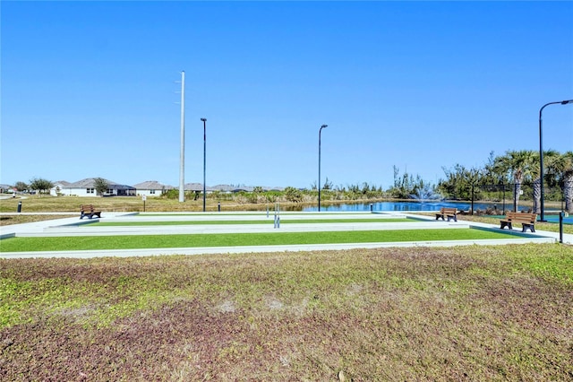 view of property's community featuring a water view and a yard