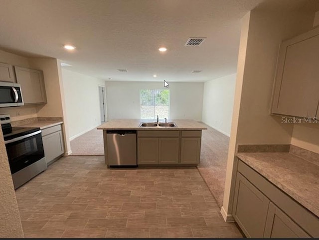 kitchen with stainless steel appliances, sink, and gray cabinets