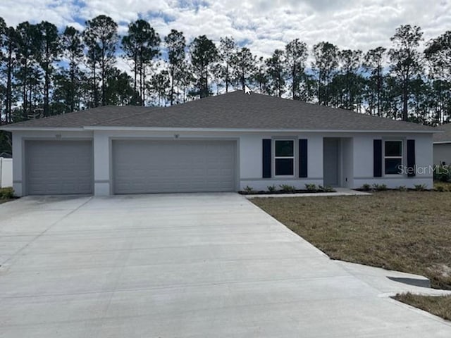 ranch-style home with a garage and a front yard