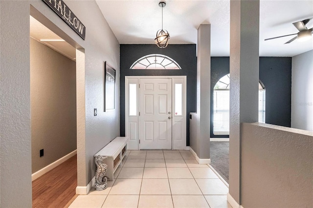 tiled entryway with ceiling fan