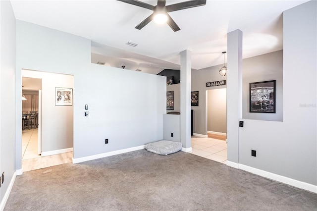 carpeted spare room featuring ceiling fan