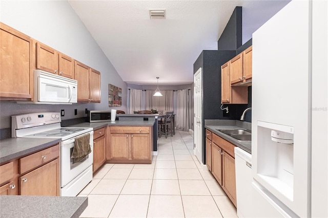 kitchen with sink, white appliances, hanging light fixtures, light tile patterned flooring, and kitchen peninsula