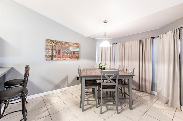 tiled dining room with vaulted ceiling